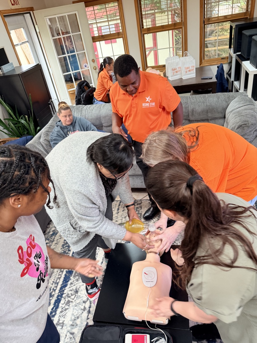 Trainees practicing CPR with a manikin and rescue mask at a 1,000 Hearts session