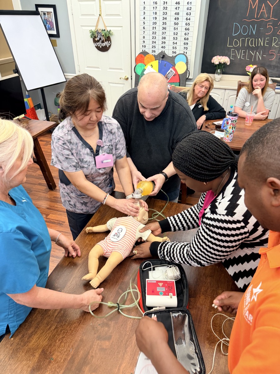 Trainees practicing infant CPR at a 1,000 Hearts training session